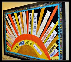 an art project is displayed on the wall in front of a bulletin board that reads new year, new beginnings and end of the year