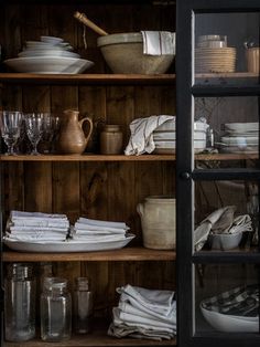 the shelves are filled with dishes and glasses