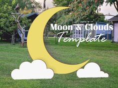 the moon and clouds template is in front of some houses with trees on either side