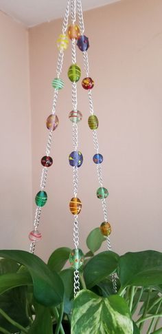 a potted plant with glass beads hanging from it