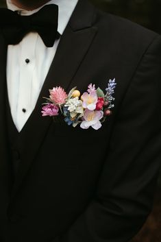 a man in a tuxedo with flowers on his lapel