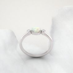 Timeless diamond and opal ring by jewelry designer Ascheron. Excellent handcrafted dainty diamond ring. Beautiful mix of brilliant cut round diamonds and smooth pear cut opal gemstone. Diamonds - 2 diamonds. Total carat weight of 0.08ct. Excellent GVS quality white diamonds. Ethically sourced. Gemstone - Real Opal, oval shape measuring 6 x 4 mm. Band - Measures 1.8 mm wide and 1.6 mm deep. Metals - Available in 14K / 18K, white, yellow or rose gold. Also in Platinum. Shipping - Free shipping to Opal Diamond Ring For Anniversary, Opal And Diamond Ring For Anniversary, Diamond Opal Ring For Anniversary, Opal Ring With Diamond Accents For Gift, Elegant Three Stone Round Opal Ring, Fine Jewelry Opal Promise Ring, Elegant Three-stone Opal Ring, Elegant Three Stone Opal Ring, Gift Opal Ring With Diamond Accents