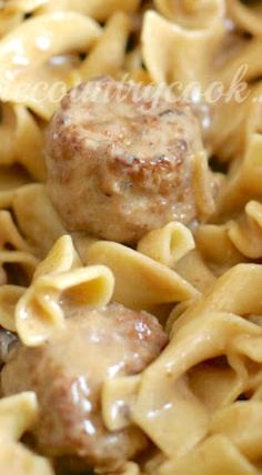 meatballs and noodles are being cooked in a skillet