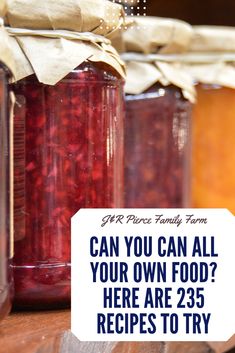 jars filled with jam sitting on top of a wooden table