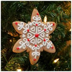 a christmas ornament hanging from a tree with lights in the shape of a snowflake