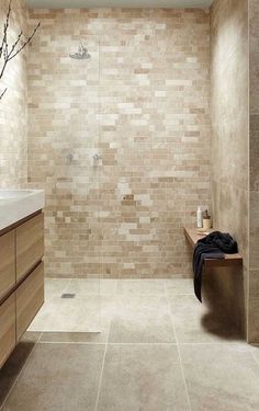 a bathroom with a sink, toilet and bathtub next to a shower head mounted on a wall