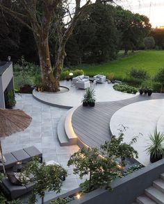 an outdoor patio with seating and trees in the background