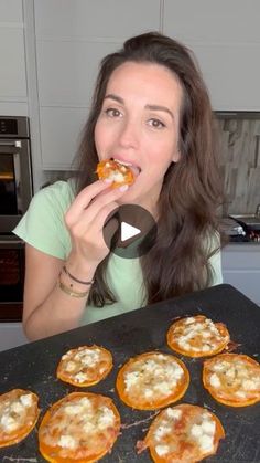 a woman is eating some food in the kitchen