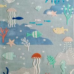 an ocean scene with fish, jellyfish and other marine creatures on blue felt board