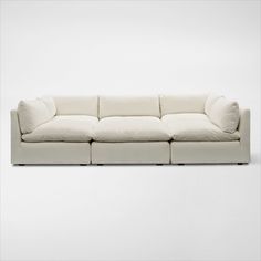 a white couch sitting on top of a white floor