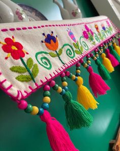 the colorful tassels are hanging on the wall