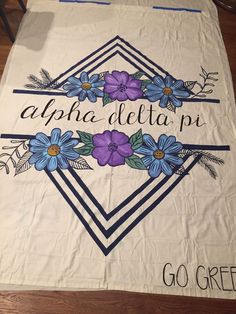 a white bag with blue flowers and the words, apha delta n go green