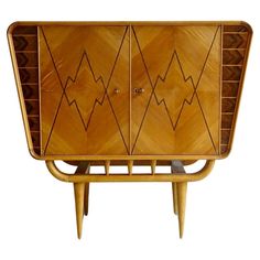 an art deco sideboard with geometric designs on the front and sides, made out of wood