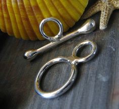 a pair of scissors sitting on top of a wooden table next to a starfish