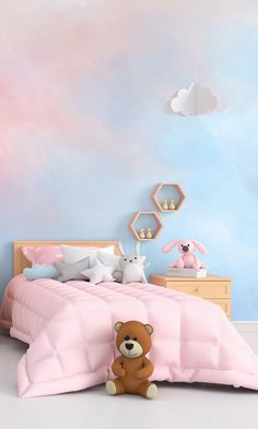 a teddy bear sitting in front of a pink bed