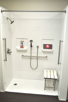 a bathroom with a shower, bench and white tile walls on the wall is shown