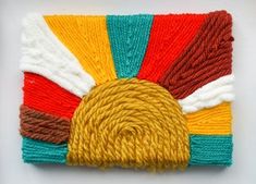 a multicolored piece of yarn on a white surface