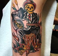 a man with a guitar tattoo on his arm