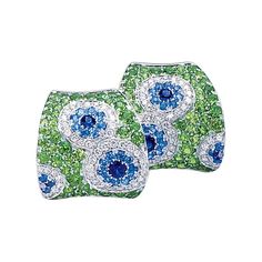 These Cellini Jewelers earrings feature a Kaleidoscope of white diamonds, and blue sapphires which are set within a green tsavorite concave shaped earring. Set in 18 karat white gold. The earrings have a fold down post with a french clip making them suitable for pierced and non pierced wearers. This whimsical design is part of the Exclusive collection created for Cellini Jewelers by renowned craftsman Carlo Barberis of Italy. Carlo Barberis impresses with his use of gemstones and unpredictable c White Gold Hoops, Jewelry Design Drawing, French Clip, Jeweled Earrings, Semi Precious Jewelry, Whimsical Design, White Gold Earrings, Jewelry Brand, Blue Jewelry