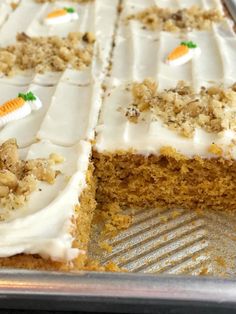 a carrot cake with white frosting on a pan