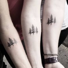 two people with matching tattoos on their arms