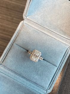 a diamond ring sits in a velvet box