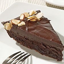 a piece of chocolate cake with nuts on top