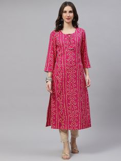 This Rani Pink Bandhani Print Straight Kurta from Piroh exhibits dori tassels with triangle lace detail along with Round Neck & 3/4th Sleeves. Tailored from Rayon. Product Length: 46 Inches. Description Size - Measuring Unit  :  Regular Size                                 :   ( S, M, L, XL, XXL )  Shape Type                    : Straight Length Type                   :  Calf Length Color                                : Rani Pink Ideal For                          :  Printed Occasion Spring Anarkali Kurta With Bandhani Print, Festival Kurta With Printed Motifs, Bohemian Kurta With Self Design For Transitional Season, Bohemian Kurta With Self Design, Cotton Kurta With Tassels For Navratri, Festival Kurta With Tassels, Diwali Long Sleeve Kurta With Tassels, Spring Traditional Kurta With Tassels, Traditional Spring Kurta With Tassels