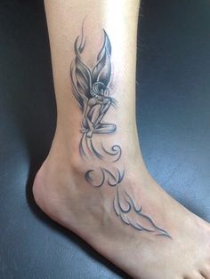 a woman's foot with a bird tattoo on it