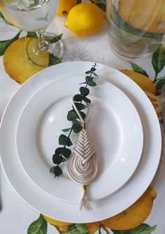 a table setting with lemons and white plates