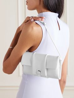 Proenza Schouler's '90s-inspired 'Flip' bag debuted on the label's Spring '24 runway. Defined by its soft pillowy structure, it's crafted from supple leather and has an adjustable shoulder strap. It opens up to dual compartments - one features zipped pockets for your cards and coins, while the other is sized to hold your phone and lipstick. White Baguette Bag With Dust Bag For Evening, White Baguette Bag For Evening With Dust Bag, White Luxury Baguette Bag For Evening, Luxury White Baguette Bag For Evening, White Flap Bag With Magnetic Closure For Evening, Modern Baguette Shoulder Bag With Dust Bag, Modern White Baguette Bag For Evening, Modern White Flap Bag For Evening, 90s Bag