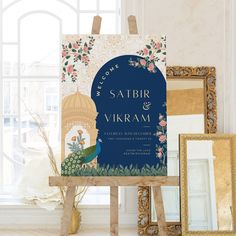 the wedding card is sitting on top of an easel in front of a window