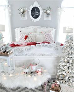 a bedroom decorated for christmas with white furniture and decorations