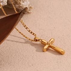 Indulge in luxury with the Delaney Cross Necklace. Made with exquisite craftsmanship, this stunning piece will add a touch of elegance to any outfit. The delicate cross design symbolizes strength and grace, making it the perfect accessory for any fashion-forward individual looking to make a statement. Elevate your style and make a lasting impression with this beautiful necklace. Item Details: 18Kt Gold Plated Stainless Steel Water Resistant Tarnish Resistant Hypoallergenic Color: Coloration in t Minimalist Gold Plated Cross Necklace, Elegant Pendant Cross Necklace With Clavicle Chain, Elegant Cross Pendant Necklace With Clavicle Chain, Elegant Silver Cross Necklace, Crucifix Cross Necklace With Clavicle Chain As Gift, Classic Cross Clavicle Chain Necklace, Tarnish Resistant Spiritual Cross Jewelry, Elegant Pendant Cross Necklace With Adjustable Chain, Elegant Necklace With Clavicle Chain And Cross Pendant