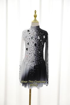 a black and white dress on a mannequin with sequins in it