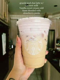 a person holding up a starbucks drink in their hand with the caption that reads, grand cafe chat latte / vanilla sweet cream cold