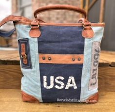 Blue two tone tote canvas and leather bag crafted of repurposed and upcycled sustainable Military Canvas into this great purse or tote bag. Plenty of room for everything you need. Convenient front pocket and adjustable crossbody strap make it the perfect bag to show your pride with ease, d comfort and style! A perfect gift for all those patriotic peeps, military moms, wives and all that just love a quality bag. 17" x 14.5" x 4" <<-- Please Check the DIMs! Fully Lined Inside Zip top Closure Leath Upcycled Tote Shoulder Bag For Everyday, Upcycled Everyday Tote Shoulder Bag, Upcycled Canvas Shoulder Bag For Daily Use, Everyday Upcycled Tote Canvas Bag, Everyday Upcycled Tote Shoulder Bag, Everyday Upcycled Canvas Tote Bag, Daily Use Upcycled Satchel Shoulder Bag, Upcycled Rectangular Canvas Bag, Rectangular Upcycled Canvas Bag