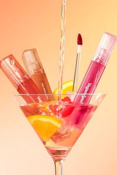 a martini glass filled with different types of lip balm