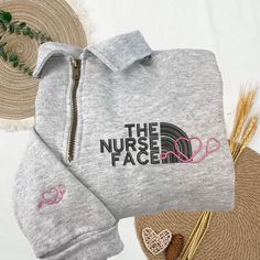 the nurse face sweatshirt and pants are next to some straws on top of a table