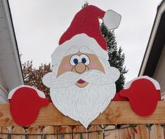 a wooden fence with a santa clause on it