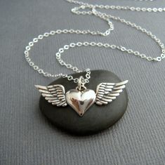 "silver heart with wings necklace. sterling silver memorial pendant. small simple heart charm. winged heart jewelry gift for her angel memory - A small solid sterling silver heart with wings pendant, measuring 1 1/4\" (3.2 cm) across, just over 3/8\" (10 mm) in length. - Heart with wings is blackened (oxidized) to make the details stand out. - Necklace is 1.5 mm sterling silver cable chain, length customizable at drop down menu. High quality lobster clasp and locking jump rings, all solid sterli Angel Wings Jewelry, Winged Heart, Wings Necklace, Wing Jewelry, Memorial Pendant, Angel Jewelry, Heart With Wings, Wing Necklace, Jewelry Design Necklace