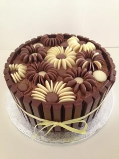 a chocolate cake with white and brown decorations