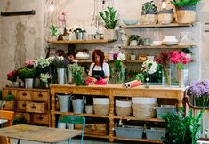 a woman is working in a flower shop