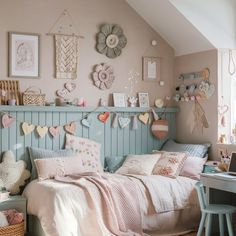 a bedroom decorated in pastel colors with hearts on the wall