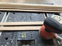 an electric sander being used to polish wood planks