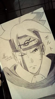 someone holding up a drawing of naruto