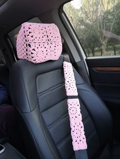 pink crocheted seat covers in the back of a car