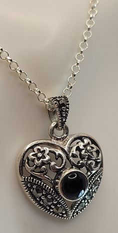 "This is a lovely heart pendant in the art nouveau style, with black onyx, marcasite in sterling silver on a 15 inch vintage sterling silver choker I almost called the pendant dainty, but to be more accurate this is a substantial (or even chunky) pendant for such a dainty chain and this combination would work well for a dainty person to wear a substantial piece. Call it \"Chunky for a Dainty Person?\" East Village Bangles is the product of love ❤️, a unique collection of vintage jewelry painstakingly restored by Casey in the East Village. Even as we put love, sweat (and sometimes tears!) into restoring these items, it is our policy that you must be thrilled. We stand behind every item and we will take it back if it is not for you." Victorian Silver Jewelry For Valentine's Day, Vintage Sterling Silver Heart Necklace Nickel Free, Antique Silver Nickel-free Heart Pendant, Elegant Heart Jewelry With Oxidized Finish, Elegant Heart-shaped Jewelry With Oxidized Finish, Elegant Heart-shaped Oxidized Jewelry, Antique Silver Heart Pendant Jewelry, Antique Silver Heart Jewelry With Oxidized Finish, Victorian Silver Heart Pendant Jewelry