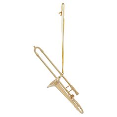 an ornament shaped like a trombone hanging from a hook on a white background