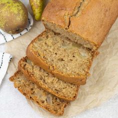 sliced loaf of banana bread next to two pears